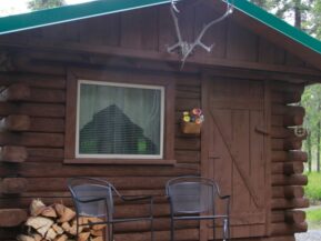 Exterior view of Grub Steak cabin with two chairs for relaxing on porch