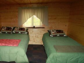 Twin beds in Grub Steak cabin