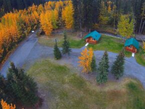 Aerial view of cabins with mountains in the distance