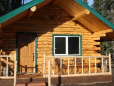 Exterior view of Eagle's Nest cabin with chairs on porch for relaxing